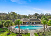 Thumbnail 55 of 67 - a mansion with a large pool and palm trees