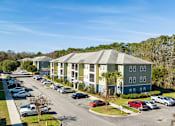 Thumbnail 20 of 39 - A sunny day at a residential area with cars parked in a row.