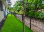 Thumbnail 36 of 41 - a chain link fence with a grassy area next to it