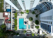 Thumbnail 4 of 66 - a rendering of a building with a pool and a parking lot