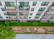 Thumbnail 34 of 41 - an aerial view of an apartment building with green grass and trees in front of it