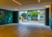 Thumbnail 12 of 41 - a large open space with a large mural on the wall
