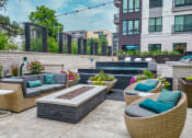 Thumbnail 33 of 41 - an outdoor patio with couches and a firepit
