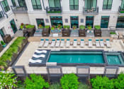 Thumbnail 31 of 41 - an aerial view of the pool and lounge area at the lawrenceville apartments in lawrence