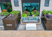 Thumbnail 35 of 41 - a seating area with couches and a coffee table in front of a building