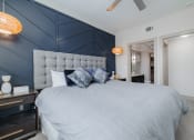 Thumbnail 21 of 33 - a bedroom with a large bed and a blue accent wall