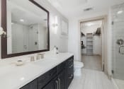 Thumbnail 23 of 33 - a white bathroom with a large mirror and a toilet
