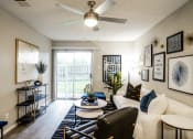 Thumbnail 3 of 33 - our apartments offer a living room with a ceiling fan and a balcony