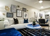 Thumbnail 5 of 33 - an open living room with a white couch and a coffee table