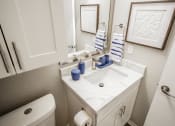Thumbnail 10 of 33 - a bathroom with a sink and a mirror and a toilet