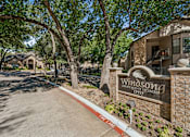 Thumbnail 17 of 22 - A sign for Windson Homes stands in front of a building.