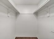 Thumbnail 16 of 23 - a walk in closet with white walls and a carpeted floor