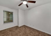 Thumbnail 11 of 23 - an empty room with a ceiling fan and a window