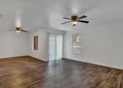 Thumbnail 3 of 23 - a bedroom with hardwood floors and a ceiling fan