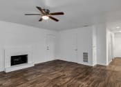 Thumbnail 5 of 23 - a living room with white walls and a ceiling fan