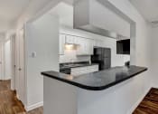 Thumbnail 7 of 23 - a kitchen with a counter top and a stove top oven