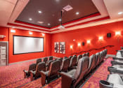 Thumbnail 28 of 48 - a room with a projector screen and chairs