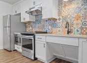 Thumbnail 36 of 44 - a kitchen with white cabinets and white appliances