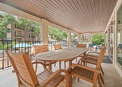 Thumbnail 35 of 44 - a patio with a wooden table and chairs