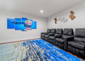 Thumbnail 37 of 44 - the living room has a large blue rug and black couches