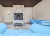 Thumbnail 44 of 44 - a living room with a fireplace and blue couches