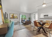 Thumbnail 7 of 44 - a living and dining room area with a table and chairs and a couch in the background
