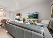 Thumbnail 5 of 44 - a living room and dining room with white walls and a ceiling fan