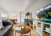 Thumbnail 1 of 44 - a living room with a couch a coffee table and a tv