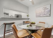 Thumbnail 6 of 44 - a dining area with a glass table and four chairs