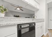 Thumbnail 9 of 44 - a kitchen with an island and a ceiling fan