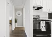 Thumbnail 10 of 44 - a kitchen in a 555 waverly unit with white cabinets and a black stove and oven