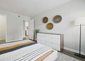 Thumbnail 13 of 44 - a bedroom with a bed and a dresser