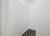 Thumbnail 16 of 44 - a bedroom with a medium hardwood floor and white walls