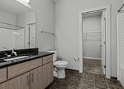 Thumbnail 5 of 17 - A bathroom with a toilet, sink, and bathtub.