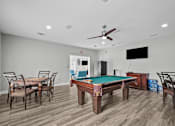 Thumbnail 24 of 26 - A room with a pool table and a television.