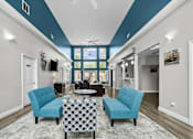 Thumbnail 20 of 26 - A living room with a blue and white color scheme.