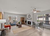 Thumbnail 5 of 26 - A modern living room with a fireplace and a dining area.