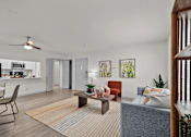 Thumbnail 6 of 26 - A living room with a grey couch and a red chair.