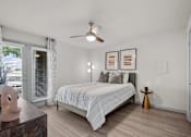 Thumbnail 8 of 26 - A bedroom with a bed, a ceiling fan, and a window with blinds.