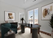 Thumbnail 14 of 42 - A living room with a blue armchair, a black table, and a painting on the wall.