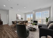 Thumbnail 12 of 42 - A modern living room with a dining table and chairs.