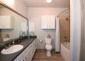Thumbnail 10 of 28 - A bathroom with a sink, toilet, and bathtub.