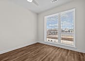 Thumbnail 31 of 42 - A room with a window covered by white blinds.