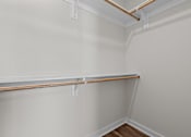 Thumbnail 34 of 42 - A white wall with a brown pipe and a white shelf.