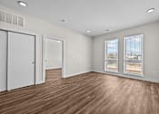 Thumbnail 30 of 42 - A room with wooden floors and white walls.