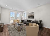 Thumbnail 2 of 42 - A living room with a black and white coffee table and a grey couch.