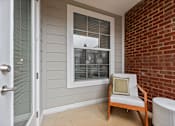 Thumbnail 23 of 39 - A chair with a pillow is placed in front of a window.