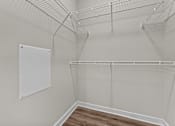 Thumbnail 13 of 39 - A white wall with a white board and a white shelf.