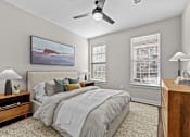 Thumbnail 14 of 39 - A bedroom with a large bed and a painting on the wall.