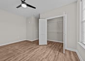 Thumbnail 34 of 39 - A room with a ceiling fan and a white closet.